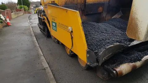 LDRS Road surfacing material including plastic pellets