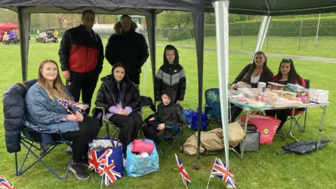 BBC People sitting under a marquee