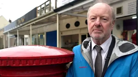 BBC Alan Bates next to a postbox