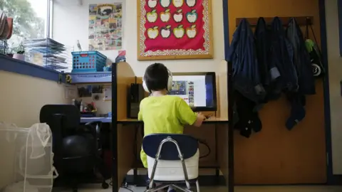 Boston Globe Boy working at desk at home