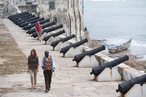 AFP US First Lady Melania Trump with Kwesi Essel-Blankson, Museum Educator, at the Cape Coast Castle, a former slave trading fort, in Cape Coast, on October 3, 2018, during the second day of her week-long trip to Africa to promote her 'Be Best' campaign.