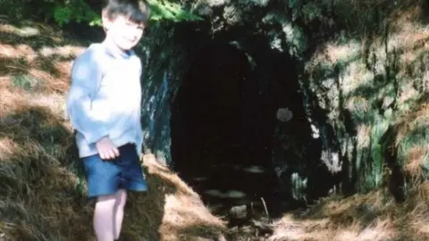 Ioan Lord Ioan at a mine entrance as a child