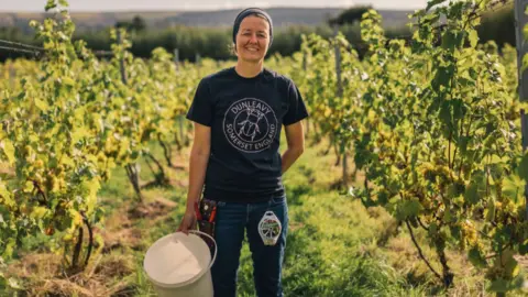 Wine grower Ingrid Bates standing in her vineyard