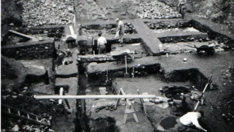 COTSWOLD ARCHAEOLOGY Black and white image of the excavation of the former Debenhams and Bon Marche site in the 1950s