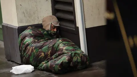 Getty Images Homeless man sleeps on the streets in London