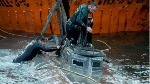 AFP Guardia Civil divers inspect the suspected narco-submarine in Aldán, Galicia