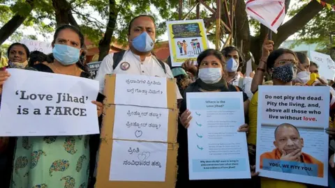 Getty Images Activists belonging to various human and civil rights organisations hold placards during a demonstration condemning the decision of various Bharatiya Janata Party (BJP) led state governments in the country for the proposed passing of laws against "Love Jihad"