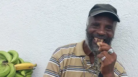 Anselm Gibbs Alain Mellow at his stall in Roseau