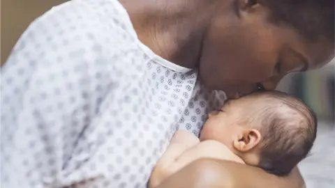 Getty Images An American mother holds her baby