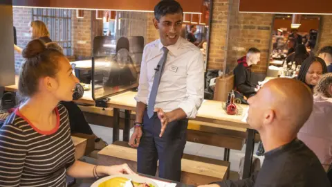 HM Treasury Chancellor Rishi Sunak speaks to diners at a Wagamamas restaurant