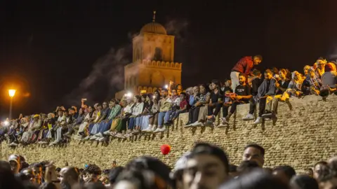 Yassine Gaidi/Getty Images Muslims on a wall for Mawlid al-Nabawi at a mosque Kairouan, Tunisia - Tuesday 26 September 2023