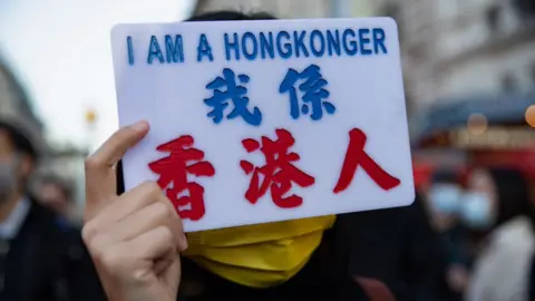 Getty Images A woman holds a sign reading "I am a HongKonger"