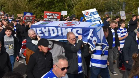 Sell Before We Dai Reading FC fans carry a coffin to protest against the club's owner