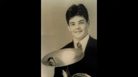 Family handout Rupert with his French horn, before the accident