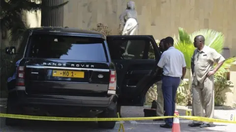 EPA Tanzanian police officers inspect a vehicle with registration number "MO 1" that belongs to Mohammed Dewji, a Tanzanian business tycoon who is said to be Africa"s youngest billionaire, parked at Colosseum Hotel and Fitness Club in Dar es Salaam, Tanzania, 11 October 2018.