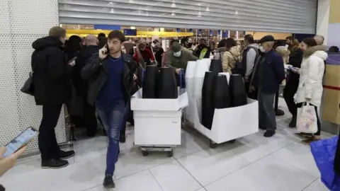 EPA Russian people buy a furniture and household goods in IKEA hypermarket before the store closes in St. Petersburg