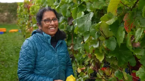 A woman standing in front of vines in Shropshire