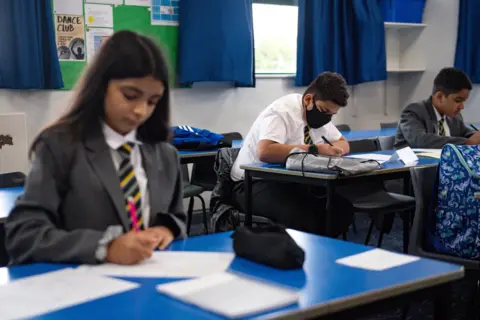PA Media children in school classroom with boy in mask