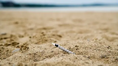 Getty Images A syringe at a beach