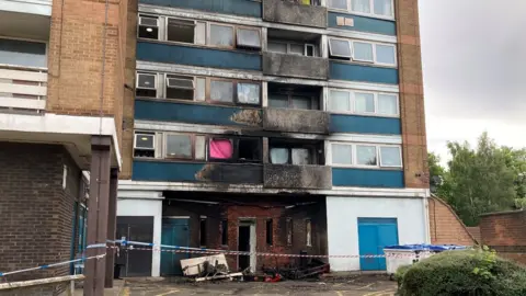 Justin Dealey/BBC Fire damage at Watford flats