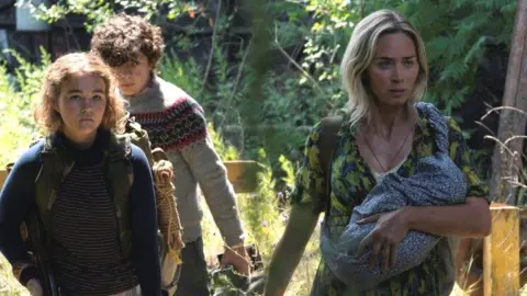 Jonny Cournoyer/Paramount Millicent Simmonds, Noah Jupe and Emily Blunt in A Quiet Place Part II