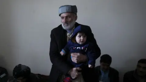 Reuters Mohammad Qasem Razawi, grandfather of baby Sohail Ahmadi, holds his grandson