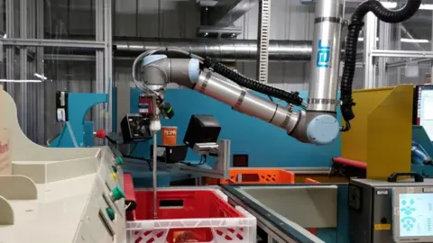 The packing robot being trained to pack goods.