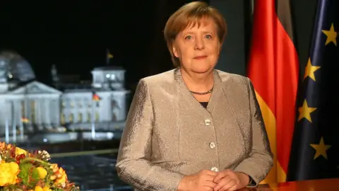 Getty Images German Chancellor Angela Merkel records her televised New Year's address to the nation at the Chancellery on December 30