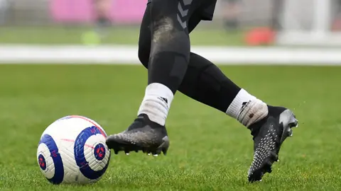 Getty Images Lower half of Afghan woman footballer (unidentified) playing in the UK, 2022