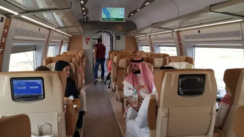 Reuters Saudis sit inside a new high-speed Haramain Express train in Jeddah, Saudi Arabia (18 September 2018)