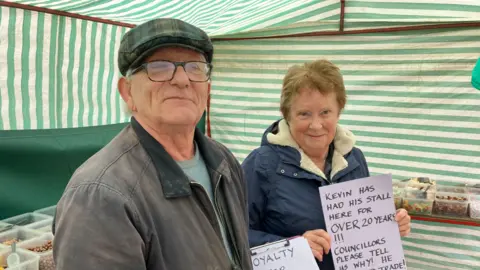 Guy Campbell/BBC Kevin Hilliard with supporters at his sweet stall