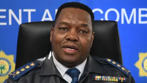 South Africa's national police commissioner Fannie Masemola is seen in uniform at a press briefing
