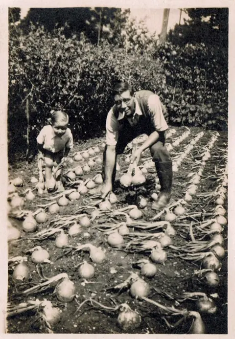 Roger Staker Clifford Staker and son Roger in an onion patch