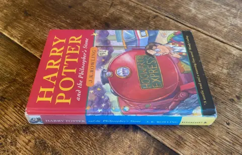 FIrst edition Harry Potter book on a wooden table