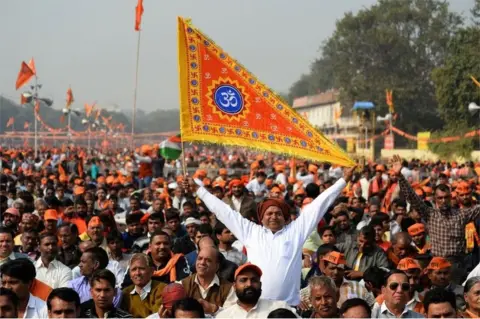 AFP An Indian Hindu hardliner holds a religious flag as he participates in a rally calling for the construction of a temple on the site of the demolished 16th century Babri mosque, located in Ayodhya, in New Delhi on December 9, 2018.