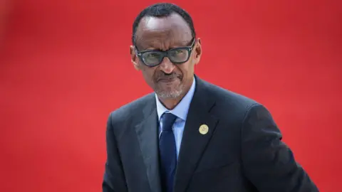 AFP An image of Rwanda's President Paul Kagame wearing a suit with a red background