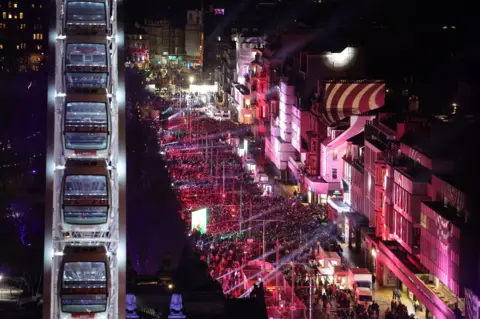 Getty Images A packed street bathed in red light viewed from a high vantage point
