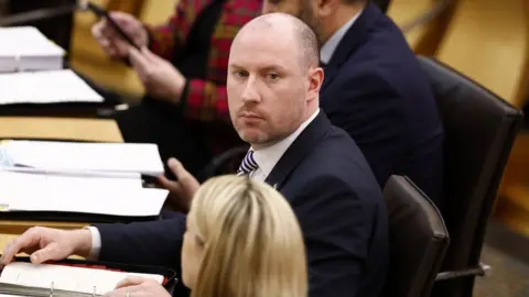 Getty Images Neil Gray in the Scottish parliament during first ministers questions