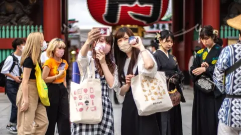 Getty Images Visitors at the Sensoji Temple in Tokyo.