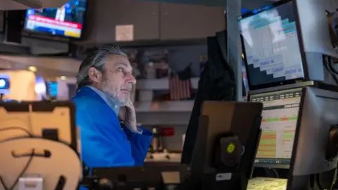 A trader watches the market