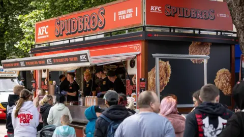 Headland People queue up outside a pop-up catering van selling KFC