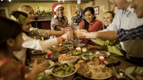 Getty Images Family enjoying Christmas dinner