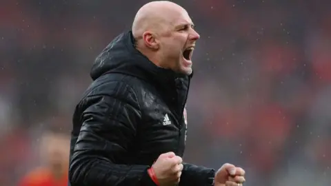 Getty Images Rob Page, Head Coach of Wales celebrates after their sides victory which qualifies Wales for the 2022 FIFA World Cup during the FIFA World Cup Qualifier between Wales and Ukraine at Cardiff City Stadium