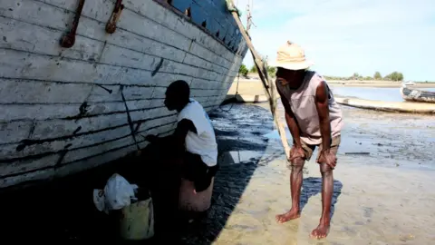 Tim Healy A shipbuilder supervises the work of his son on one of their boats