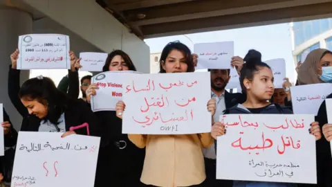 Reuters Women holding placards