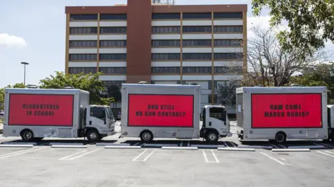 PA Three buses saying: "Slaughtered in school", "and still no gun control?", "How come, Marco Rubio?"