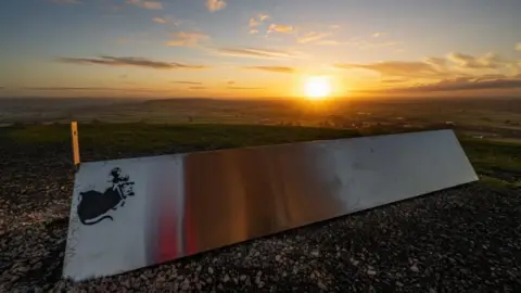 Michelle Cowbourne Banksy monolith, Glastonbury Tor