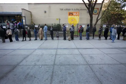 Getty Images Voters queue in New York state,