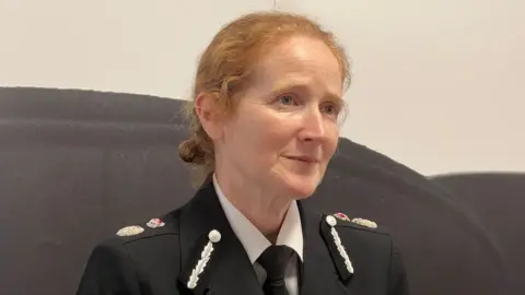 BBC A woman with ginger hair in a police uniform