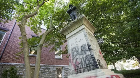 Getty Images Graffiti on a monument to a Confederate soldier in Maryland